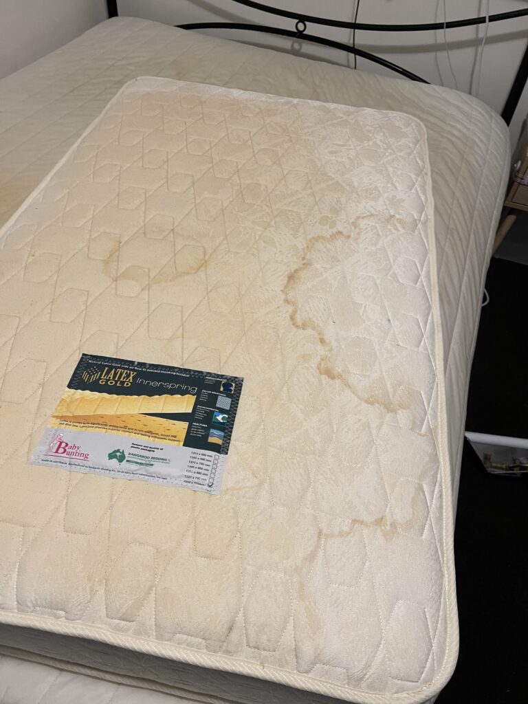 Before: Stained mattress, deep cleaned
